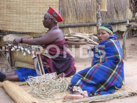 Woman in Zulu village Working Zulu woman in tourist village. (South ...