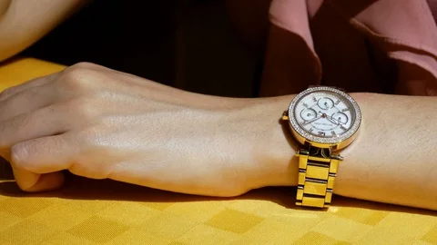 Woman's Arm with Brilliant Rose Gold Watch turning her Wrist, 4K Stock Footage
