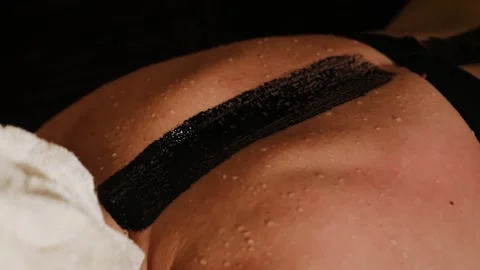Woman's back is sweating during beauty treatment in sauna SPA. Sweat drops on Stock Footage 148963580