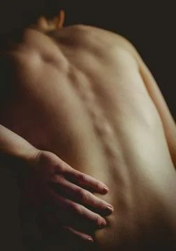 Woman's bare back and spine is being accentuated in 3D render by soft highlights Stock Photos