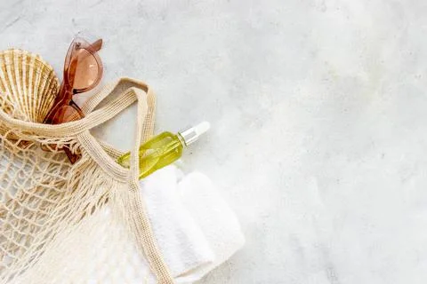 Woman's beach accessories - grid string bag with sunglasses and towel Stock Photos