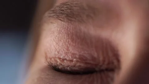 A woman's beautiful eye squints in the sun. Macro close up of the eye Stock Footage 130752685