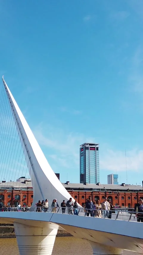 Woman's Bridge Cable Stayed Pedestrian Bridge with Walking Tourists and Puerto Stock Footage 336261307