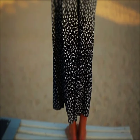 Womans clothes fluttering in the wind at sunset on the beach Stock Footage 69463669