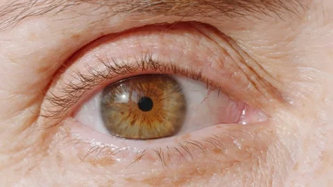 Woman's eye close up opening looking at camera macro photography Stock Footage 263314197
