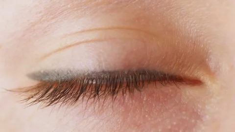 The woman's eyeball looks at the camera for a long time Stock Footage 243776019