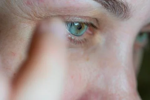 A woman's face in close up doing an eyebrow correction Stock Photos