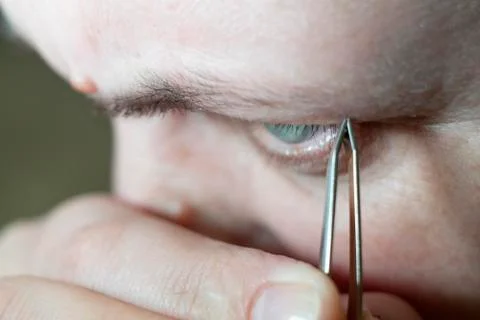 A woman's face in close up doing an eyebrow correction Stock Photos