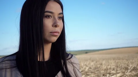 Woman's face close up in a field at sunset. Stock Footage 96987205
