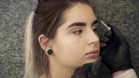 Woman's face closeup after the eyebrow correction procedure Stock Footage 73677129