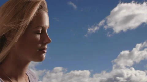 Woman's face with clouds in the background. Stock Footage 43680706