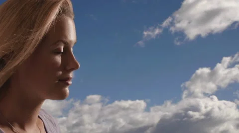 Woman's face with clouds in the background. Stock Footage 43680717