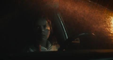 Woman's Face Illuminated Through Rainy Car Windshield Stock Footage 308387955