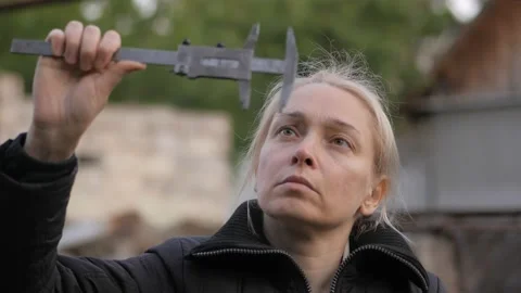 The woman's face, looking for dial caliper Stock Footage 130499178