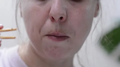 Womans face as she eats udon noodles with chicken Video stock 346781657