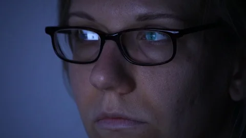 Woman's face working on a computer at night, scrolling, overtime Stock Footage 92251274