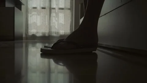Woman's feet approach bed, remove flip-flops, and lie down, relaxing Stock Footage 285663007