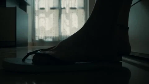 Woman's feet approach bed, remove flip-flops, and lie down, relaxing Stock Footage 302500581