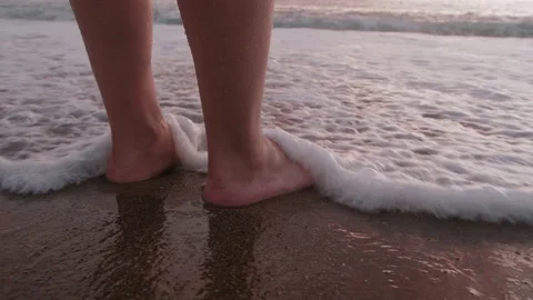 Woman's Feet In Waves At Beach Close-Up 動画素材 169864804