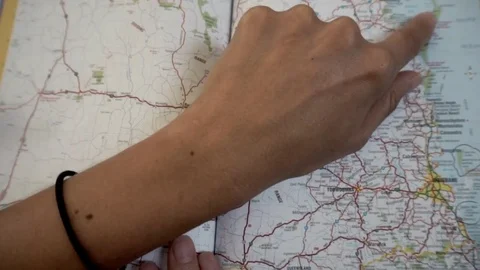 Woman's finger  pointing on a map of Australia Stock Footage 73845356