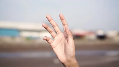 Woman's finger waving at the sky Stock Footage