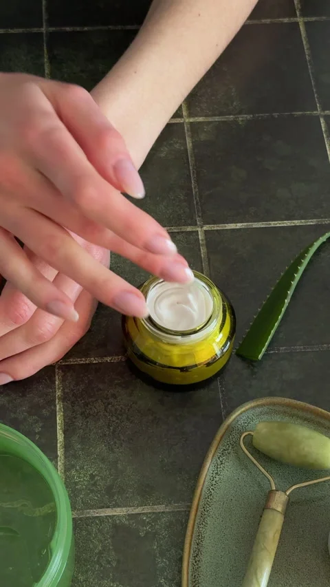 Woman's fingers dipping into a jar of moisturizing white cream Stock Footage 332490859