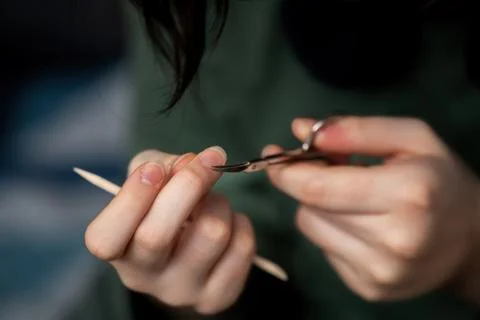 Woman's fingers using small scissors to trim cuticles, showcasing a nail ca.. Stock Photos