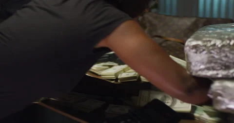 Woman's fist slams down on table and pushing money and drugs off top Stock Footage 142365693