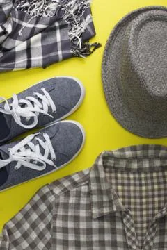 Woman's flat lay clothes gray hat sneakers scarf shirt Stock Photos