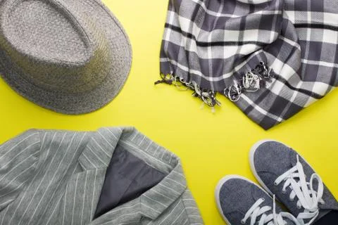 Woman's flat lay clothes gray hat sneakers scarf jacket Stock Photos
