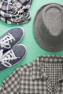 Woman's flat lay clothes gray hat sneakers scarf shirt Stock Photos