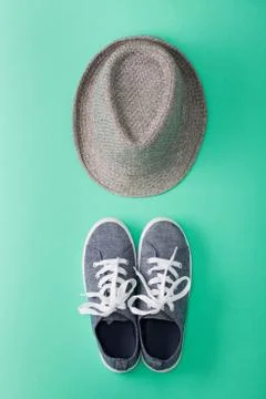 Woman's flat lay clothes gray hat and gray sneakers Stock Photos