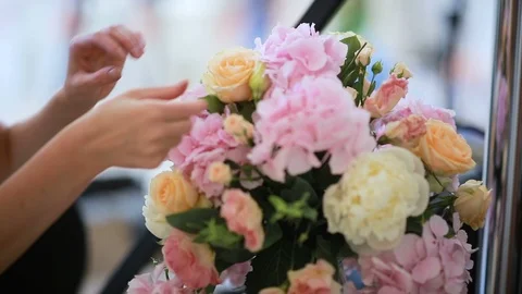 Woman's florist's hands making bouquet with different flowers, flower's shop Stock Footage 107376591