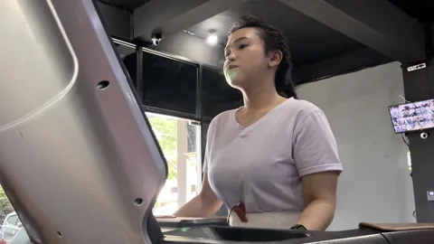 Woman's Focused Cardio Routine on a Treadmill at the Indoor Gym Stock Footage 307801028