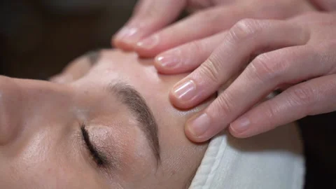 A woman's forehead is massaged Stock Footage 143022235