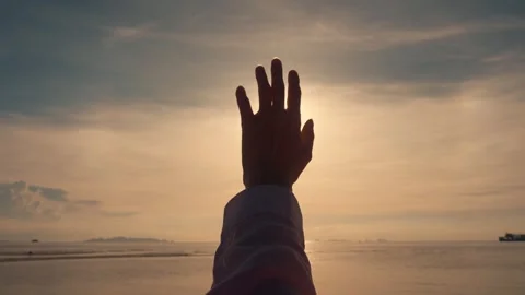 A woman's hand against the background of the summer sky. Close-up of a chewy Video stock 250108846