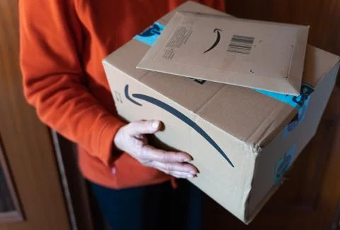Woman´s hand with Amazon packages. Foto stock