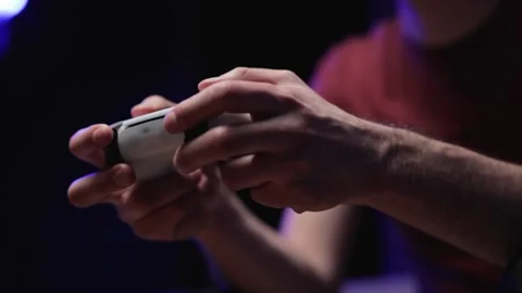 Woman's hand and console playing video games at night and pressing button in Stock-Footage 334653348