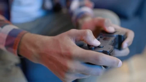 Woman's hand and console playing video games at night and pressing button in Stock-Footage 334653739