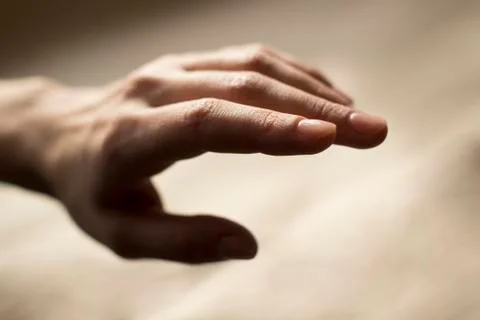 Woman's hand on beige background Stock Photos