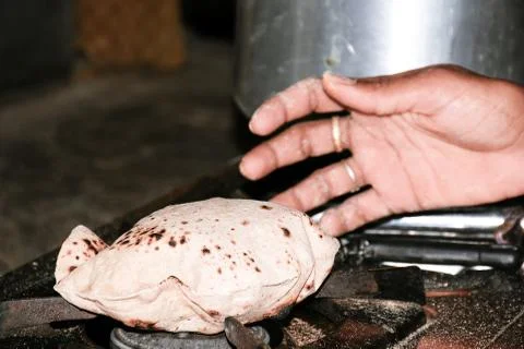 Woman's hand bread roasted on LPG Stock Photos