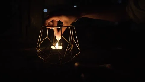 Woman's hand with burning match lights candle Stock Footage 171293788