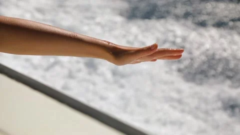 A woman's hand catching waves from the speedboat. Stock Footage 201092597