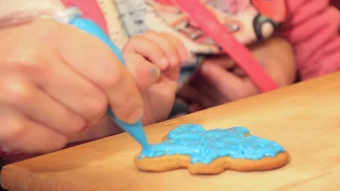 Woman's hand causes the blue paint on the cake Stock Footage 101818313