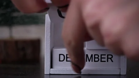 Woman's Hand Changes the Date on a White Wooden Calendar to the New Year Stock Footage 226180641