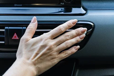 Woman's hand checking car air conditioner vent Fotos Stock