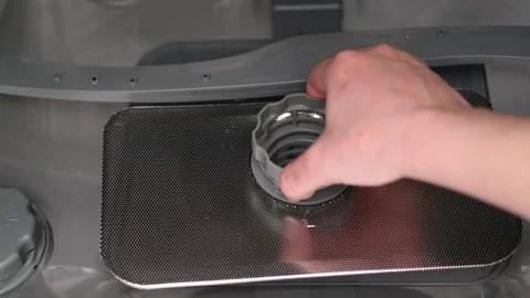 Woman's hand checking the filter in the dishwasher Stock Footage 294869448
