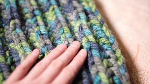 Woman's hand choosing large binding Brioche Stitch thick acrylic synthetic sheep Stock Footage 121343408