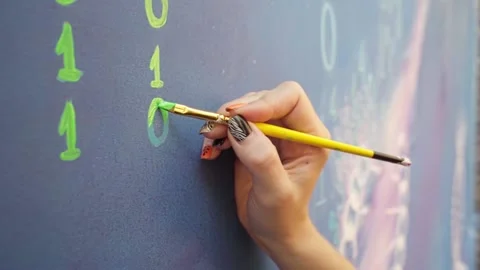 A woman's hand close-up draws the number zero with a yellow brush. Video stock 228991210