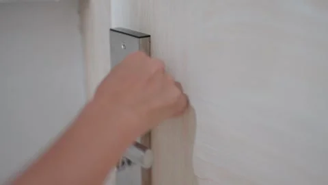 Woman's hand closes the door lock to protect herself and her safety when she sle Video stock 273134784